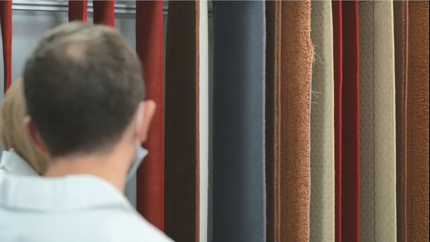 An engineer reviews carpets.